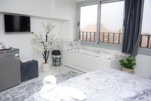 Postel nebo postele na pokoji v ubytování NEW ASSER HOTEL PYRAMID