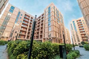 a tall building with a sign in front of it at 1BR Signature Apartment in Sharjah in Sharjah