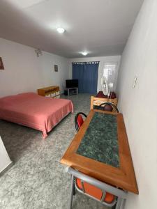 Ένα ή περισσότερα κρεβάτια σε δωμάτιο στο Amanecer Las Grutas