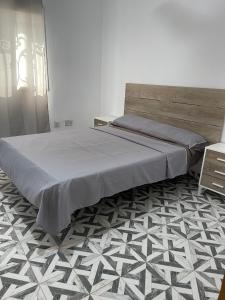 a bedroom with a large bed and a floor at Seven Apartments in Serekunda