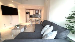 a living room with a couch and a table at Dúplex ático familiar by Prestigi in Terrassa