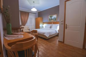 A bed or beds in a room at Asteras Hotel