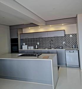a large kitchen with a stove and a refrigerator at Montagu Villa 2 in Mossel Bay +8 photos
