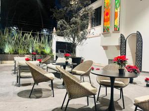 a group of tables and chairs in a patio at Hotel Casa Ensenada Luxury Boutique Hotel in Mexico City