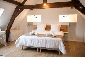 a bedroom with a large bed in a attic at A l'Orange Sanguine in Binche +42 photos