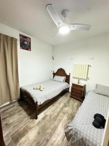 a bedroom with two beds and a ceiling fan at Villa La Rioja Casa de los abuelos in Logroño +19 photos