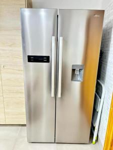 a stainless steel refrigerator in a kitchen at Villa La Rioja Casa de los abuelos in Logroño