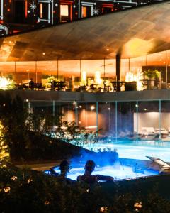 a swimming pool at night in a building at Lido Palace - The Leading Hotels of the World in Riva del Garda
