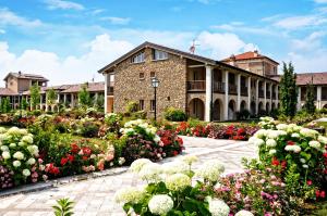a building with flowers in front of it at Garda Apartments San Vigilio Golf in Pozzolengo