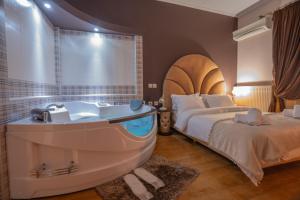 A bed or beds in a room at Asteras Hotel