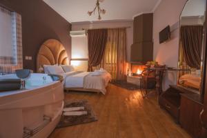 A bed or beds in a room at Asteras Hotel