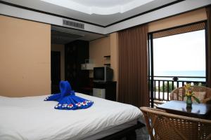 a bedroom with a bed with a blue cape on it at Lanta Sea House in Ko Lanta