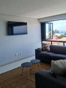 a living room with a couch and two tables at Montagu Villa 3 in Mossel Bay