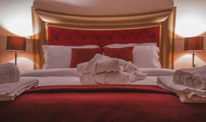 A bed or beds in a room at Asteras Hotel