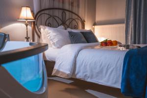 A bed or beds in a room at Asteras Hotel