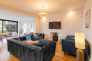 a living room with two couches and a tv at Host & Stay - Bay View House in Grange Over Sands