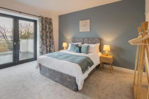 a bedroom with a large bed and a window at Host & Stay - Bay View House in Grange Over Sands +27 photos