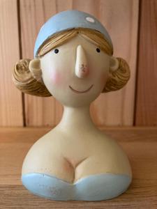 a plastic doll with a hat on a table at La Bourriche in Dolus d'Oléron