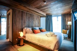 a bedroom with a large bed with wooden walls at Hotel al Piolet in Breuil-Cervinia +45 photos