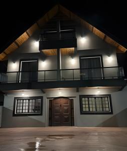 a building with a balcony on top of it at Pousada Impera - Campos do Jordão in Campos do Jordão