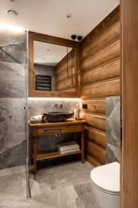 a bathroom with a sink and a toilet at Villa La Roca Garden and Spa in Kościelisko