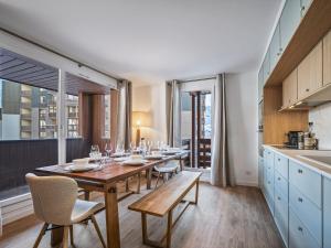 a dining room with a table and chairs and windows at Duplex modernisé 59m², 6 pers, proche pistes, Val Thorens - FR-1-640-61 in Val Thorens