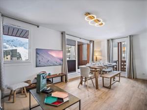 a living room with a table and chairs and windows at Duplex modernisé 59m², 6 pers, proche pistes, Val Thorens - FR-1-640-61 in Val Thorens