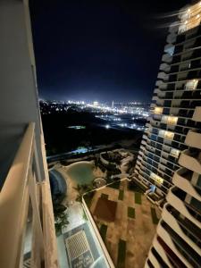 a view of a city at night from a building at Side Wall Condo in San Fernando