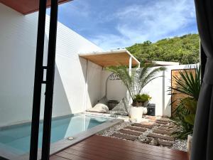 a view of a swimming pool from the balcony of a house at Tuator Villa Kohlarn in Ko Larn