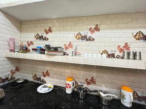a kitchen with a sink and a counter top at Om Home Stay 3BHK in Ayodhya