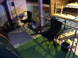 a balcony with two chairs and a tent on a house at Sandee camping by Sandee place mountain view hotel in Chom Thong