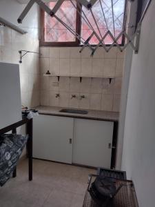 a kitchen with a sink and a window at Qqn planta baja in Quequén +2 photos