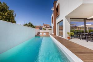 a swimming pool in the backyard of a house at Villa Adora for 6 people in Pula with private pool & children playground in Pula