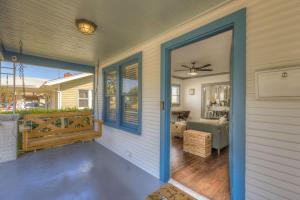 a porch with a door open to a living room at Travelin On Tulsa Time-Near Expo, TU, Downtown in Tulsa