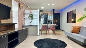 a kitchen and living room with a couch and a table at (308) Seaside - Sea View in São Luís