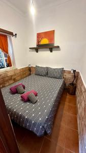 a bedroom with a bed with two pillows on it at Casa do Careca in Sagres