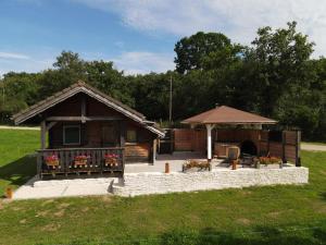 a building with a gazebo in a field at Le chalet des Etoiles in Lavans-Vuillafans +22 photos