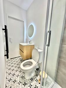 a bathroom with a toilet and a sink and a shower at Maison Familiale Le Havre in Le Havre