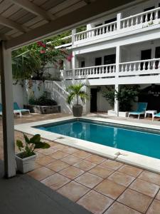 a swimming pool in front of a building at Barrel House Suite St Eustatius in Oranjestad
