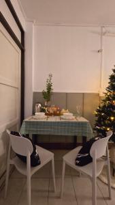a kitchen with a christmas tree and a table and chairs at Near Central Festival Hatyai#SridaHouse36,37 in Sathani Khlong Rian