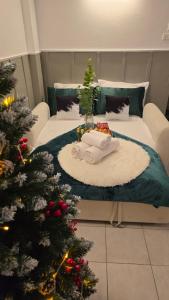 a living room with a christmas tree and a bed at Near Central Festival Hatyai#SridaHouse36,37 in Sathani Khlong Rian