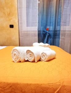 a bed with towels sitting on top of it at Wanderlust Pietralata B&B in Rome +35 photos