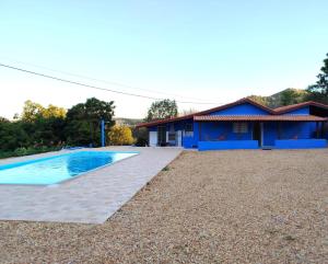 a house with a swimming pool in front of it at Casinha Virtuosa in Monte Sião