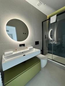 a bathroom with a sink and a toilet and a mirror at Modflor Urban Flat Florence in Florence