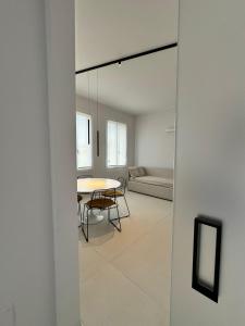 a living room with a table and a couch at Modflor Urban Flat Florence in Florence