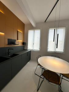 a kitchen with a table and chairs in it at Modflor Urban Flat Florence in Florence