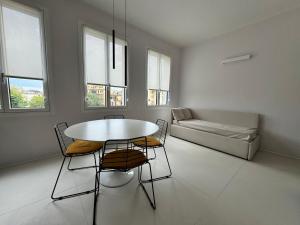 a living room with a table and chairs and a couch at Modflor Urban Flat Florence in Florence