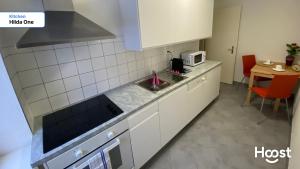 a small kitchen with a sink and a table at Hilda: Tranquillo appartamento in centro in Zürich +7 photos