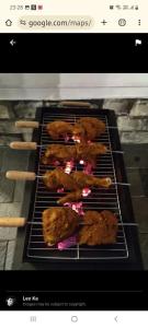 a group of chickens on a grill in an oven at Laas Villa Vagamon in Vagamon