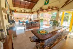 a living room with a table and a dining room at Nona Amabile in São Lourenço do Sul